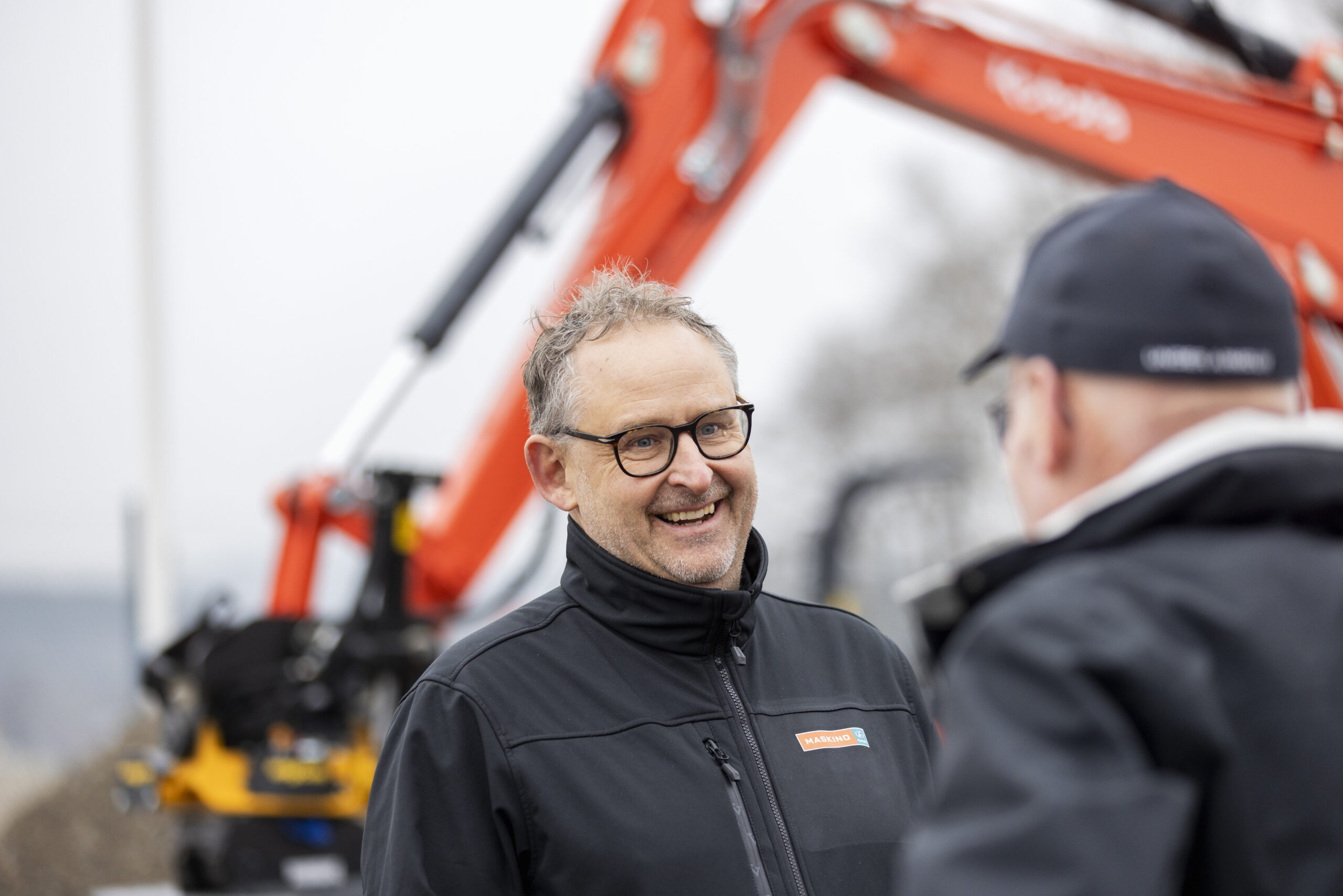 omas Andreasson, VD på Maskino, står framför en Kubota-maskin vid huvudkontoret i Munkedal.